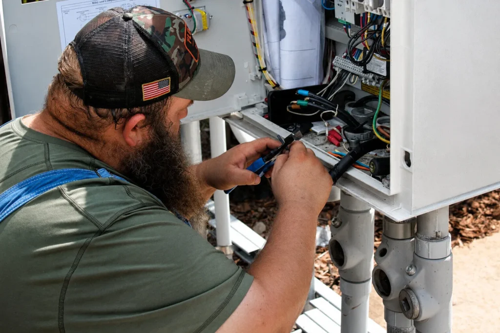Lapin Services technician inspecting residential sewer access with diagnostic equipment